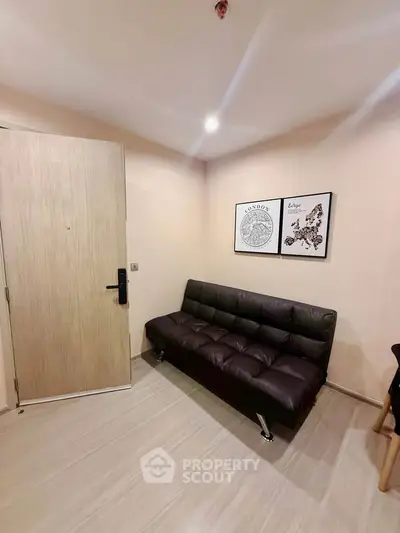 Cozy living room with modern sofa and stylish wall art in a contemporary apartment.