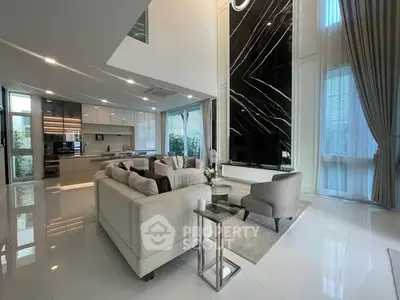 Luxurious open-plan living room with high ceilings and modern kitchen