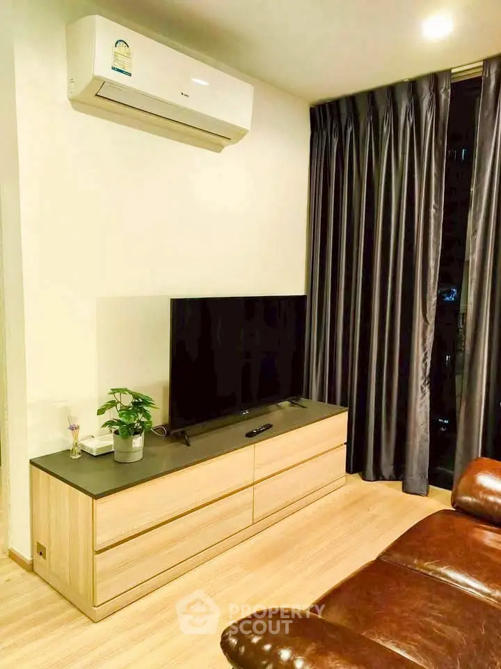 Modern living room with sleek TV setup and air conditioning