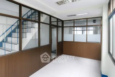 Spacious office interior with glass partitions and modern lighting