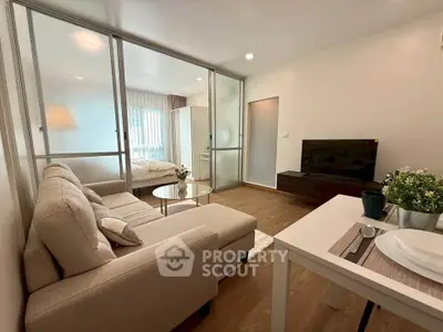 Modern open-plan living room with cozy sofa and dining area