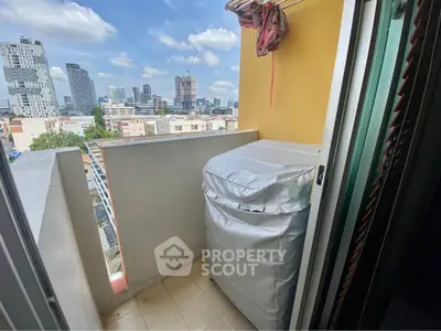 Charming city view from a cozy balcony with laundry area in urban apartment.