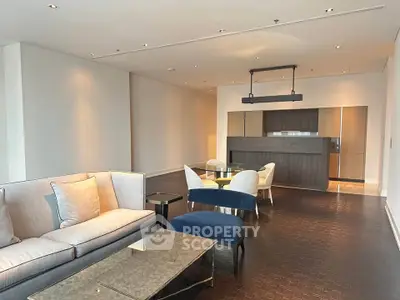 Spacious modern living room with elegant furniture and open kitchen layout.