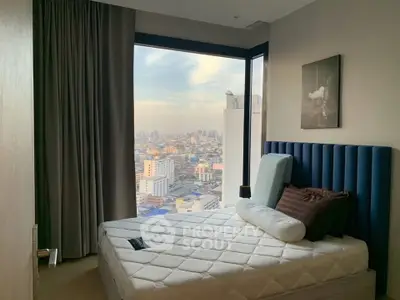 Luxurious bedroom with stunning city view from floor-to-ceiling windows in high-rise apartment.