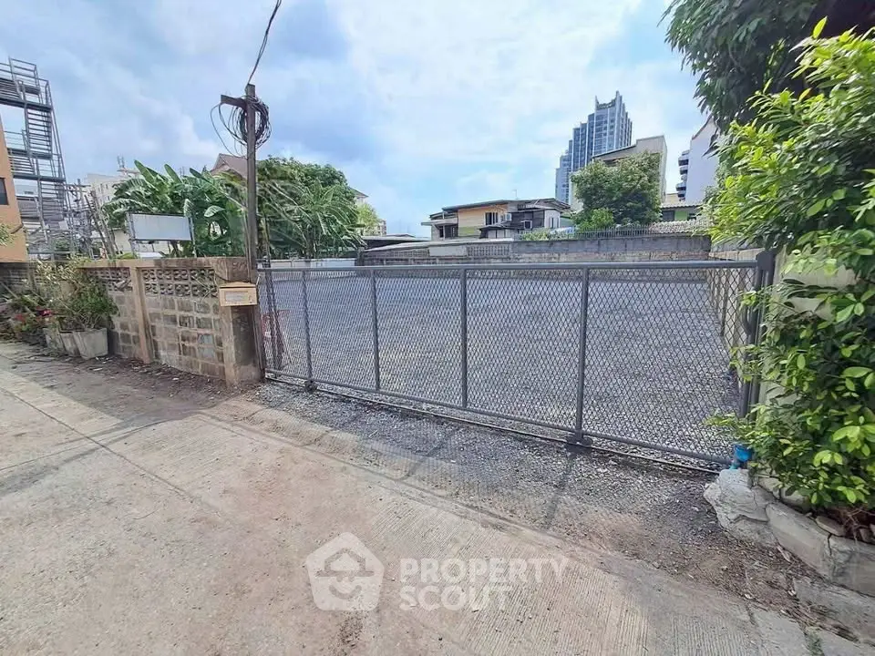 Spacious urban plot with gated entrance, ideal for development in a prime city location.