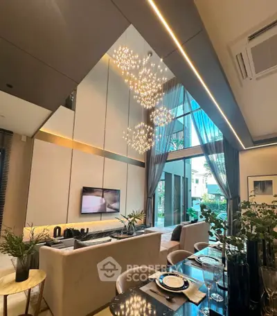 Luxurious modern living room with high ceilings and elegant chandelier