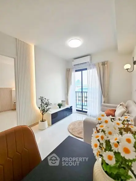 Bright modern living room with elegant decor and balcony view