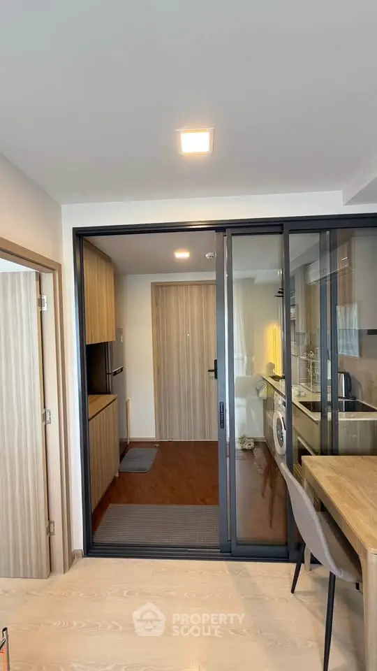 Modern kitchen with sliding glass doors and wooden flooring