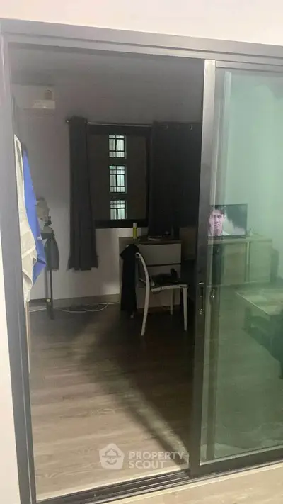 Cozy bedroom with sliding glass door and small workspace setup