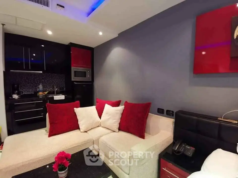 Modern living room with cozy sectional sofa and stylish kitchen corner