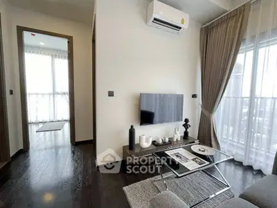 Modern living room with sleek decor and large windows offering natural light.