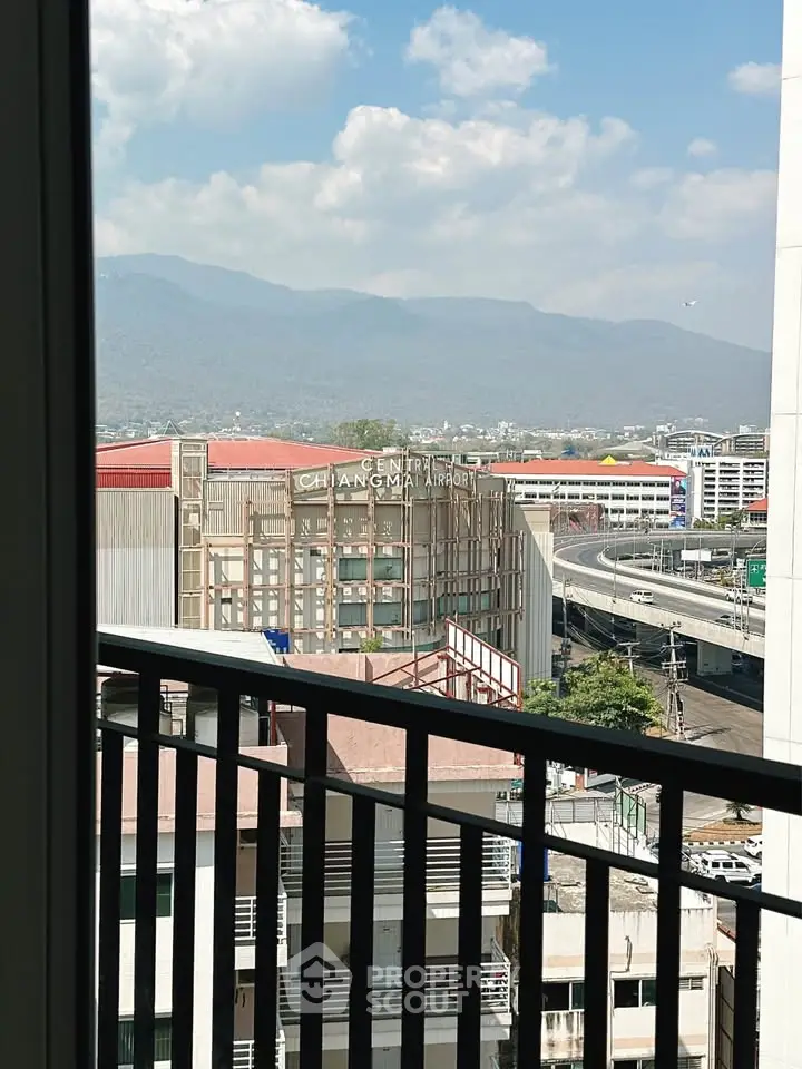 Stunning cityscape view from a high-rise balcony overlooking Central Chiangmai Airport.