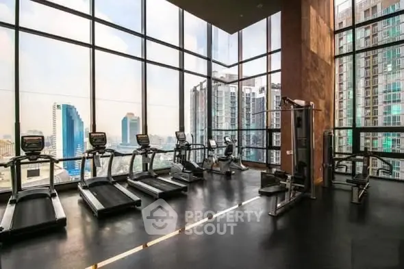 Luxury gym with panoramic city views and modern fitness equipment.