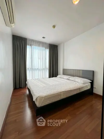 Spacious bedroom with modern design and large window for natural light