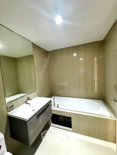 Modern bathroom with sleek design featuring a bathtub and stylish vanity.