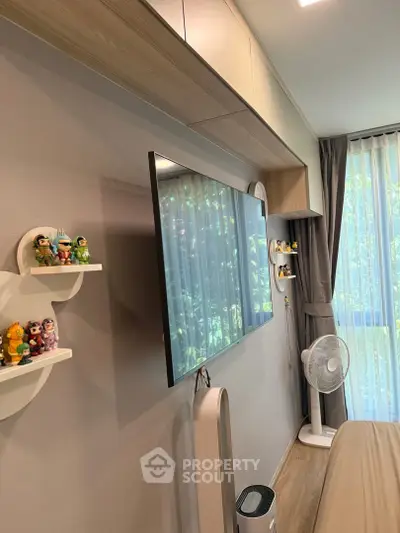 Modern bedroom with wall-mounted TV, stylish shelves, and large window with curtains.