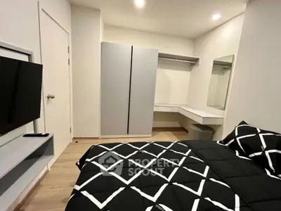 Modern bedroom with sleek wardrobe and stylish decor in a contemporary apartment.