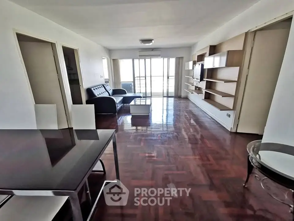Spacious living room with modern furniture and large windows for natural light.