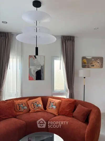 Elegant living room with modern circular sofa and stylish decor
