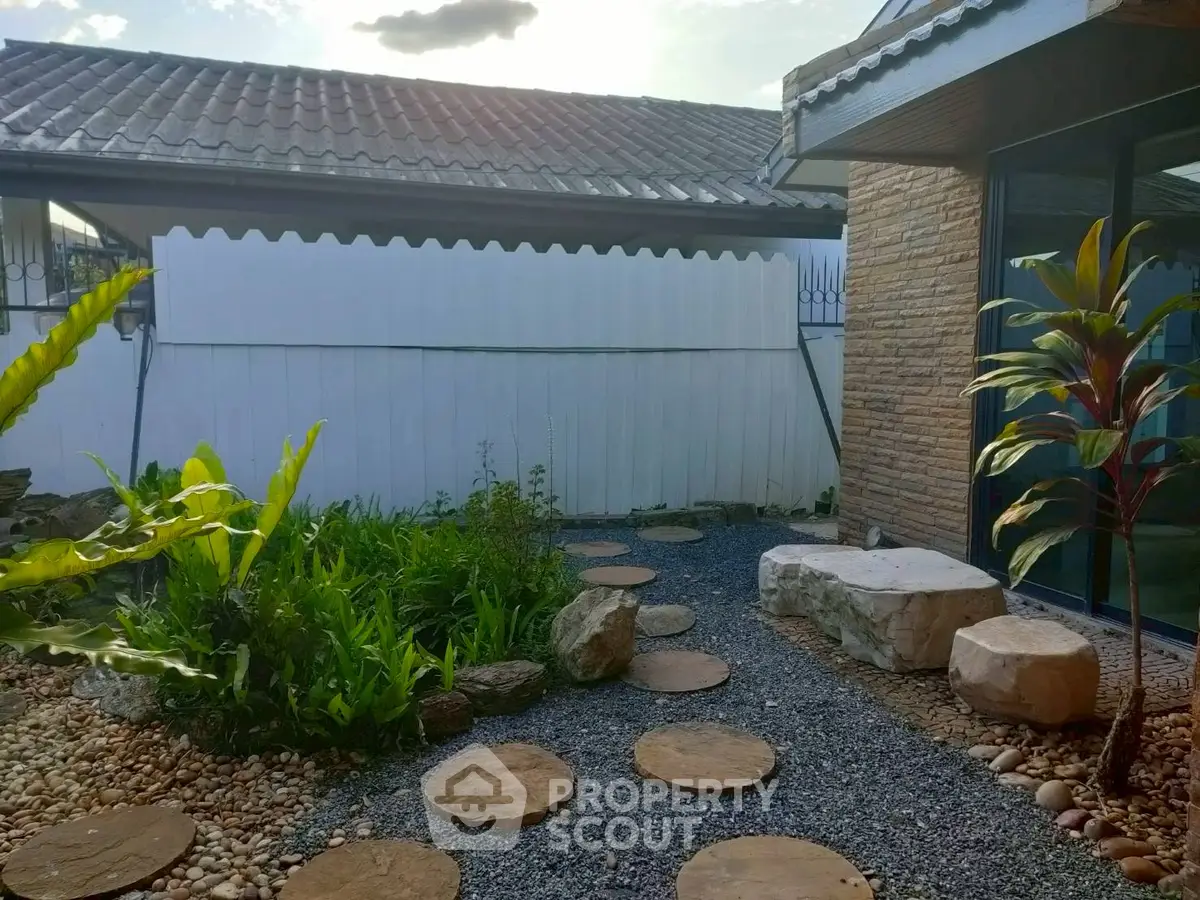 Charming garden with stepping stones and lush greenery in a serene residential setting.