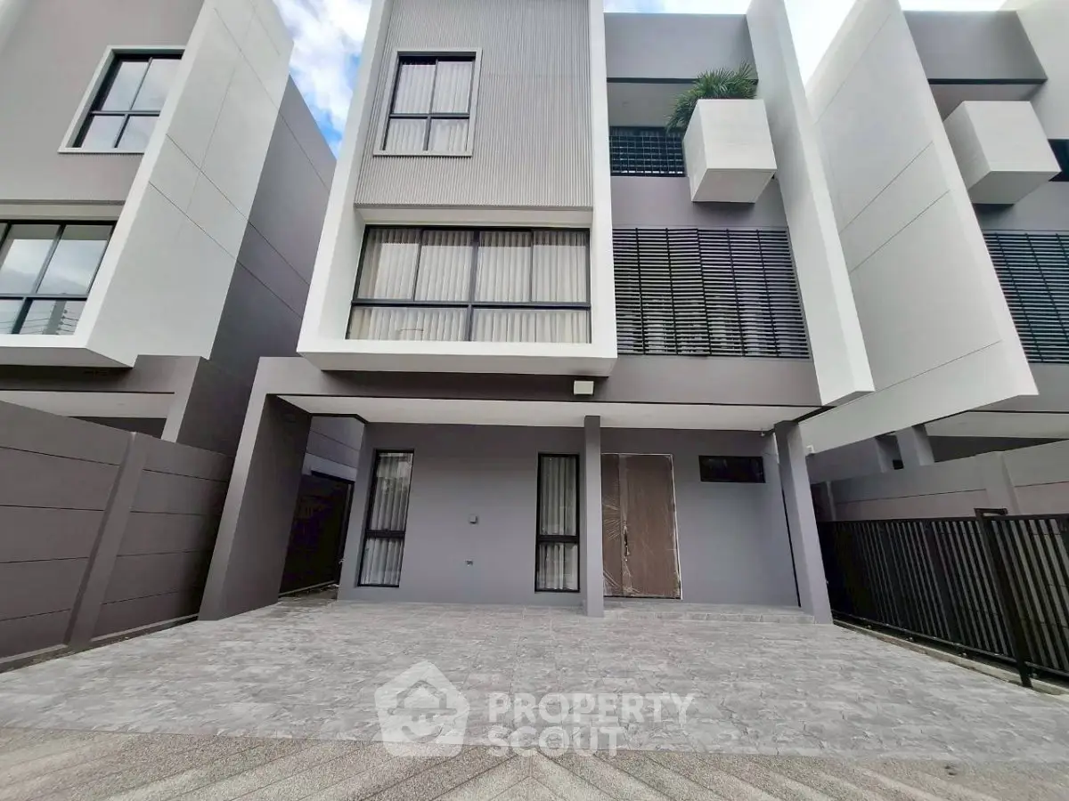 Modern townhouse exterior with sleek design and spacious driveway