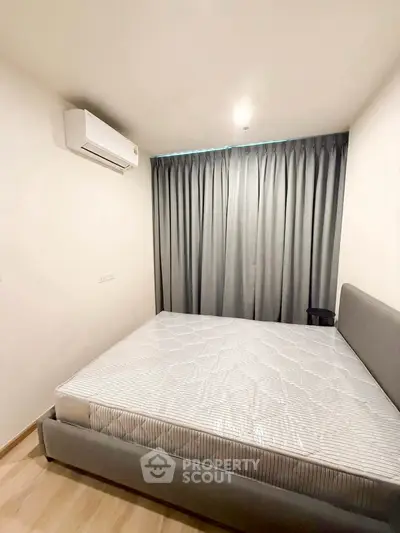 Cozy bedroom with modern air conditioning and elegant curtains