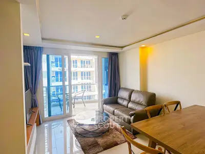Spacious living room with modern furniture and balcony view in a luxury apartment.
