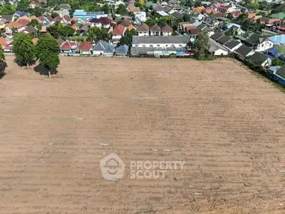 Expansive vacant land with potential for residential development in a suburban neighborhood.