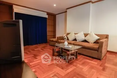 Spacious living room with cozy sofa and elegant wooden flooring