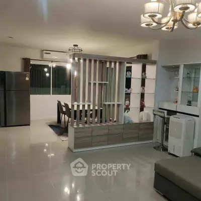 Modern open-plan living room with dining area and stylish lighting