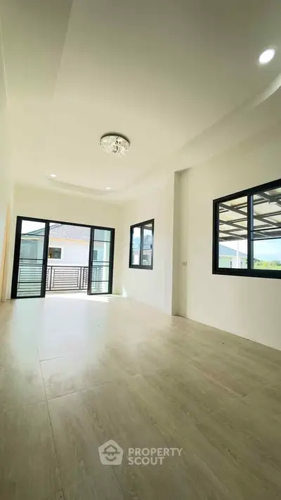 Spacious modern living room with large windows and natural light