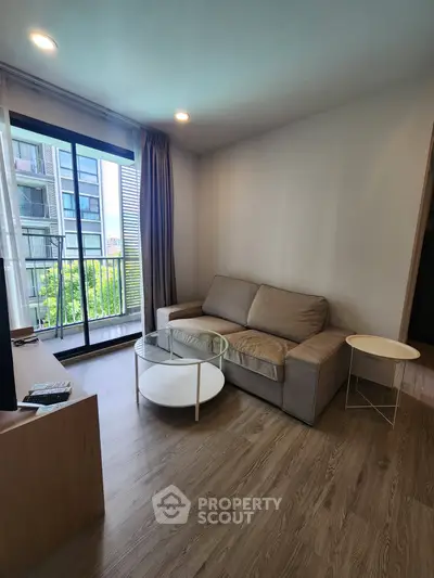 Modern living room with cozy sofa and balcony view in a stylish apartment.