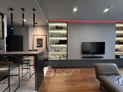 Modern living room with sleek design, wall-mounted TV, and stylish shelving.
