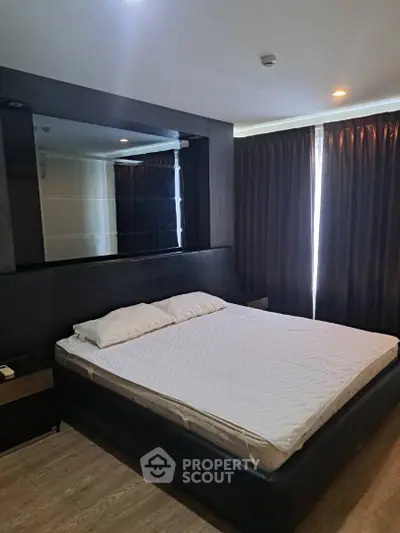Spacious bedroom with modern decor and large bed in a stylish apartment.