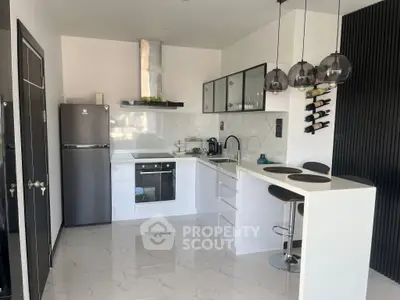 Modern kitchen with sleek white cabinets and breakfast bar
