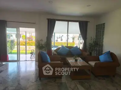 Spacious living room with elegant furniture and garden view, perfect for relaxation and entertaining guests.