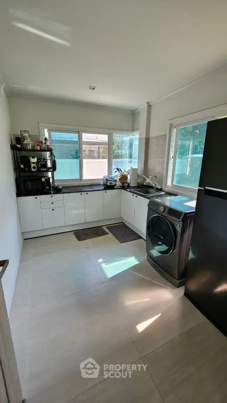Modern kitchen with sleek appliances and ample natural light