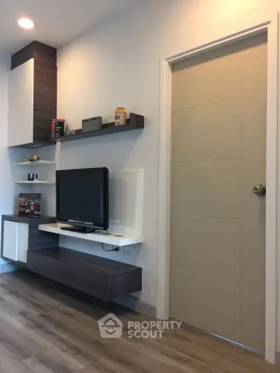 Modern living room with sleek TV unit and stylish shelving