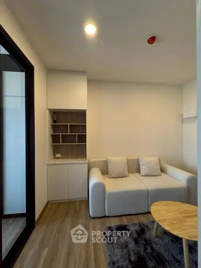 Cozy modern living room with plush sofa and stylish wooden flooring