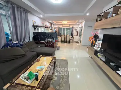 Spacious living room with modern decor and dining area, perfect for family gatherings.