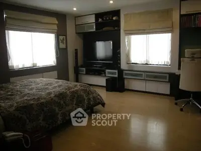 Spacious bedroom with modern decor and natural light
