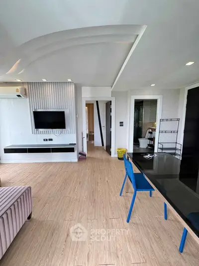 Spacious modern living room with sleek design and wooden flooring