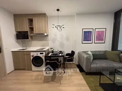 Modern living room with stylish decor, featuring a compact kitchen and cozy dining area.
