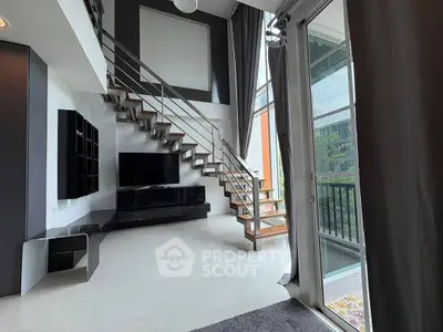 Modern duplex living room with high ceilings and large windows