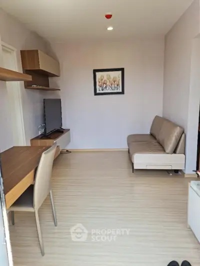 Modern living room with sleek furniture and wall-mounted TV, perfect for cozy urban living.