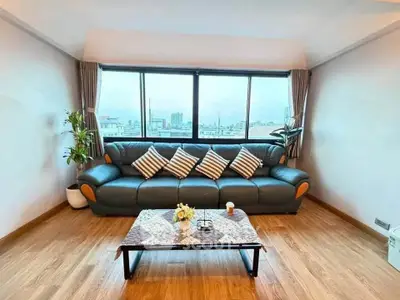 Spacious living room with large windows and stylish sofa in modern apartment