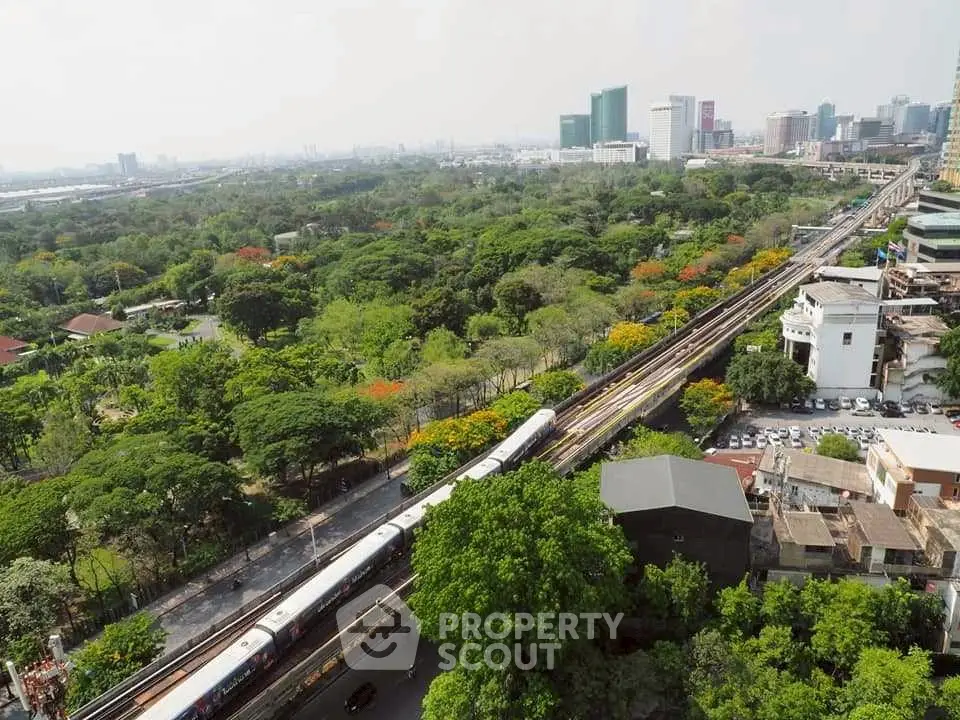 Stunning cityscape view with lush greenery and urban skyline, ideal for real estate investment.