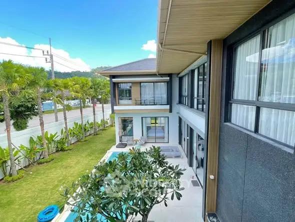 Luxurious modern home with pool and lush garden, showcasing elegant architecture and serene surroundings.