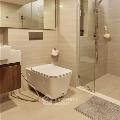 Modern bathroom with sleek fixtures and glass shower enclosure