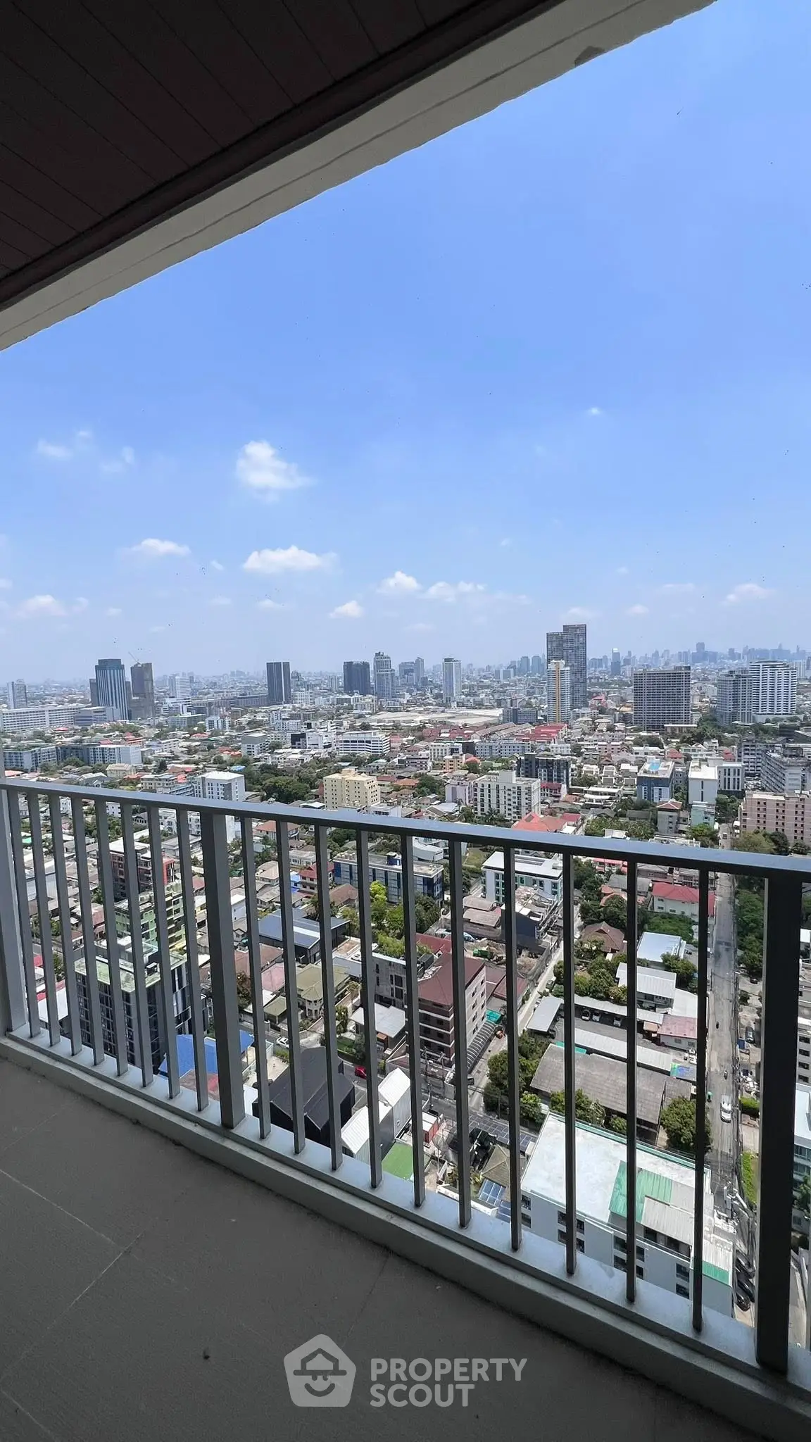Stunning high-rise balcony view showcasing city skyline and urban landscape.